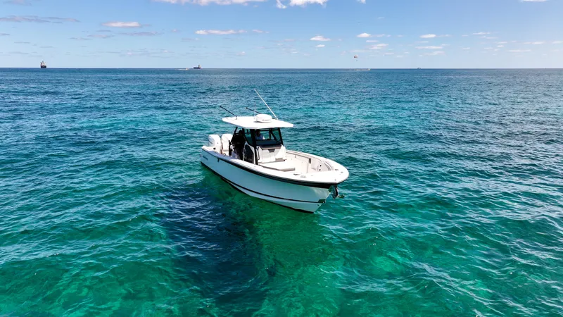 Slide: The Image of 2020 Blackfin 332 CC boat on clear blue ocean water under a sunny sky. - 7