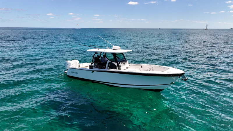 Slide: The Image of 2020 Blackfin 332 CC boat on clear blue ocean waters. - 8