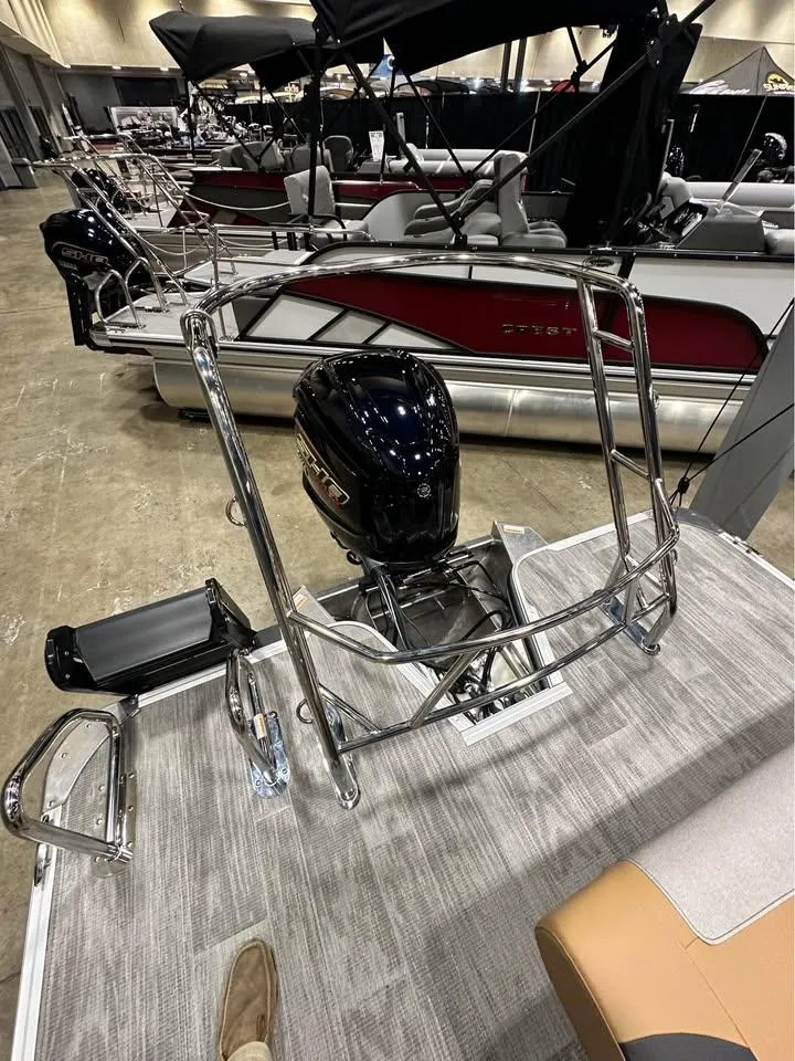 Slide: The Image of 2025 Crest Classic 240 pontoon boat with sleek design and powerful outboard motor. - 2