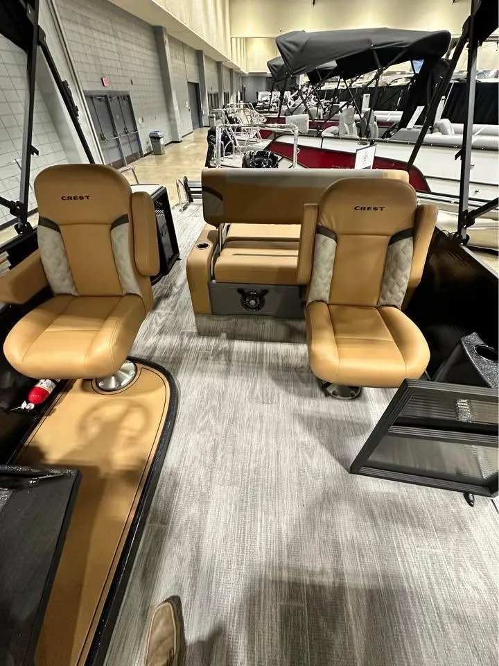 Slide: The Image of 2025 Crest Classic 240 boat interior with tan seating and modern design. - 3