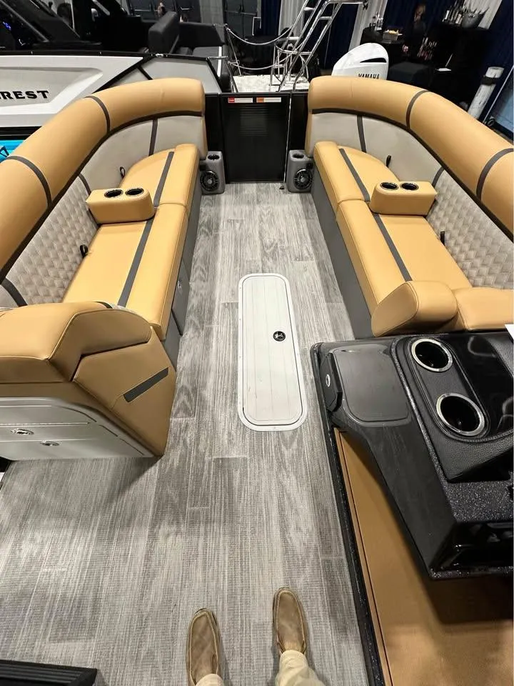 Slide: The Image of 2025 Crest Classic 240 boat interior with tan seating and modern flooring. - 4