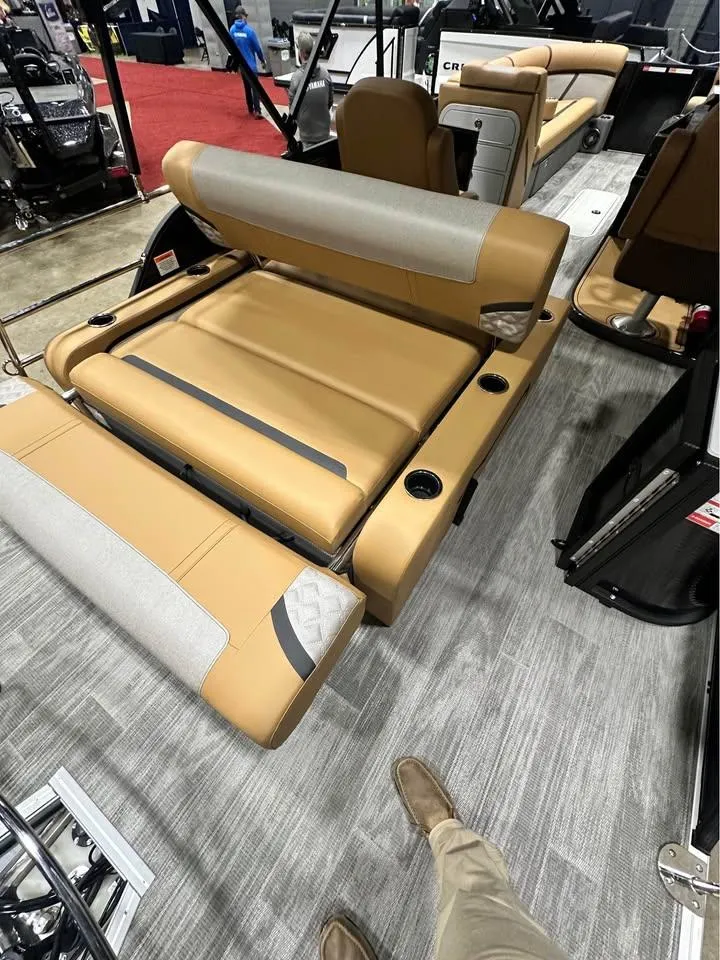Slide: The Image of 2025 Crest Classic 240 boat interior with tan seating and modern design. - 5