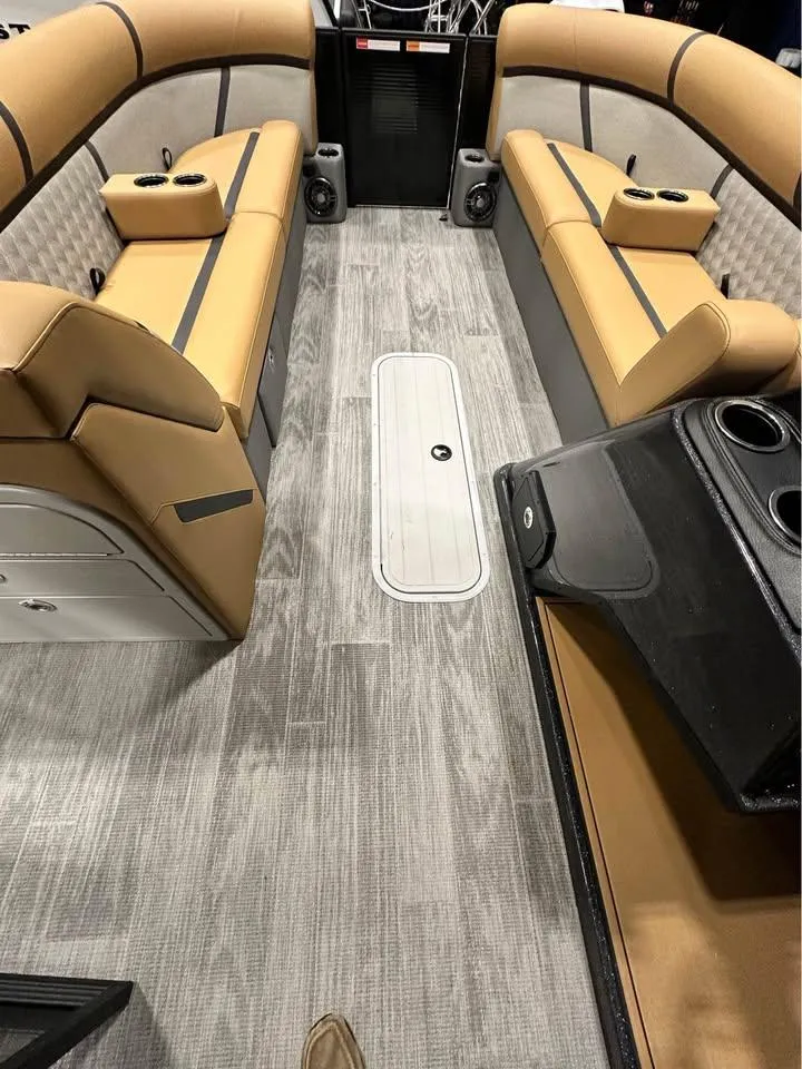 Slide: The Image of 2025 Crest Classic 240 boat interior with tan seating and modern design. - 6