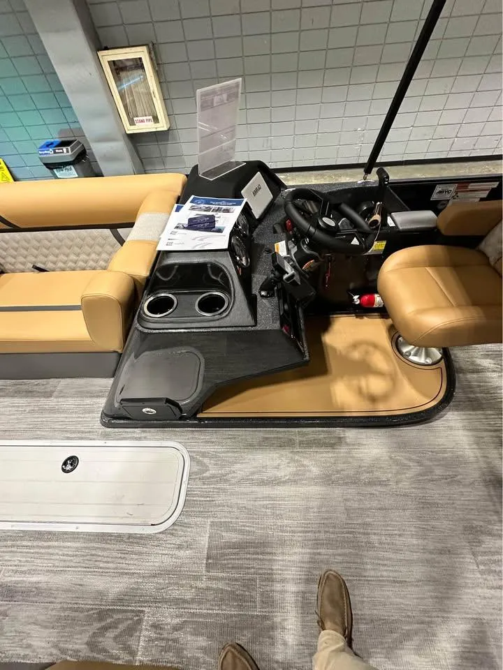 Slide: The Image of 2025 Crest Classic 240 boat interior with steering console and seating. - 7