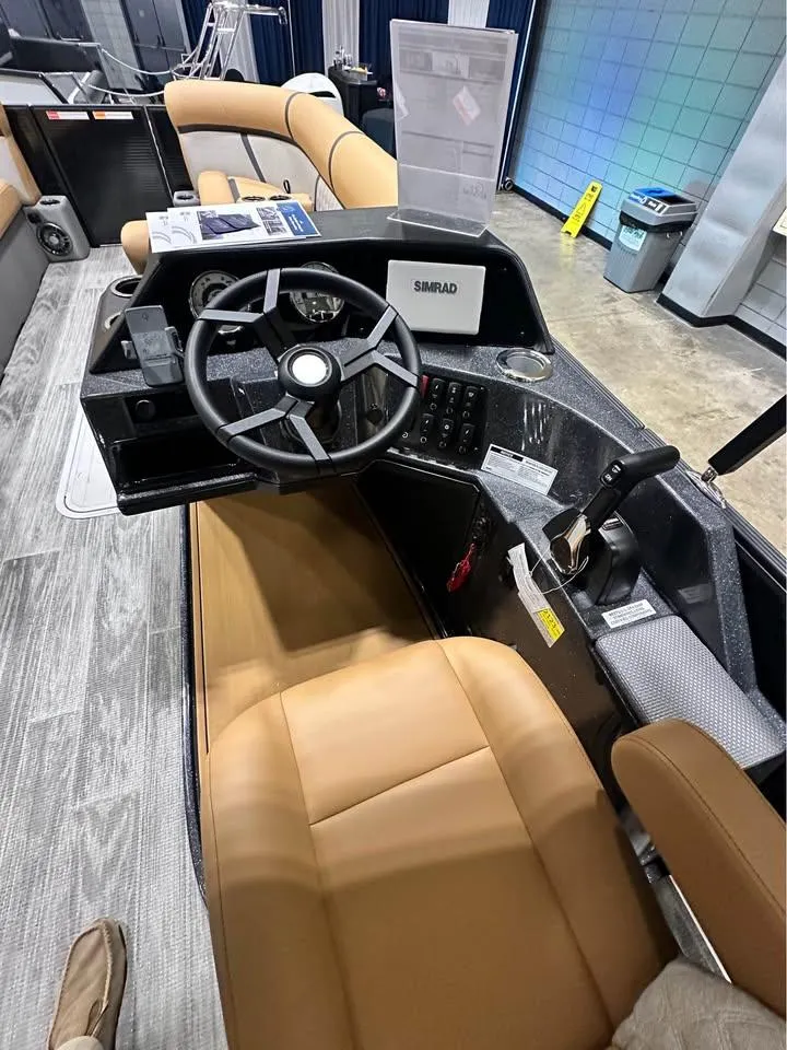 Slide: The Image of 2025 Crest Classic 240 boat interior with modern steering and tan seating. - 9