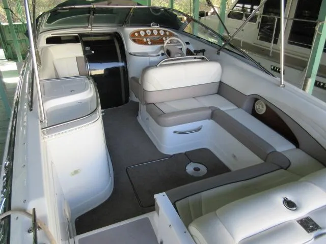 Slide: The Image of 1998 Cobalt 293 boat interior with white seating and modern dashboard. - 12