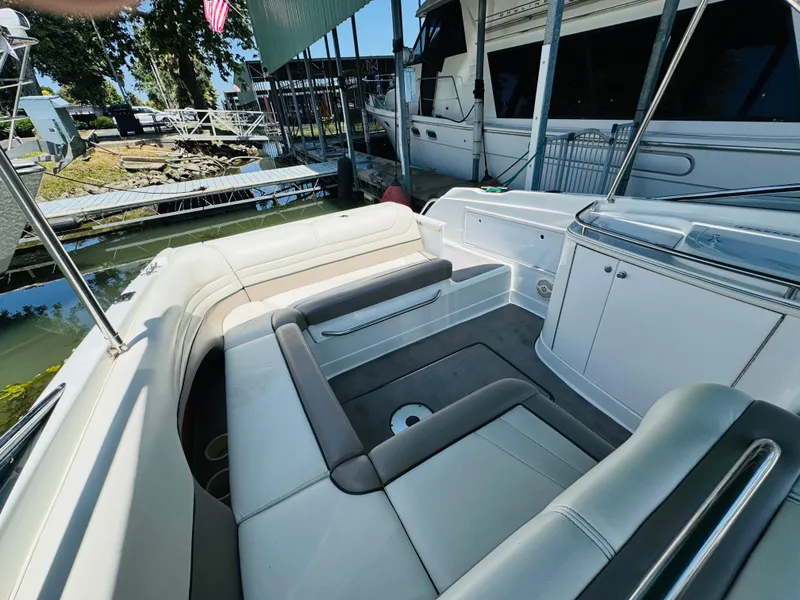 Slide: The Image of 1998 Cobalt 293 boat interior with white seating, docked near other boats. - 17