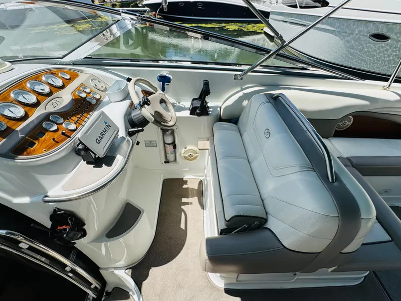 Slide: The Image of Interior of a 1998 Cobalt 293 boat with steering wheel and gray seating. - 20