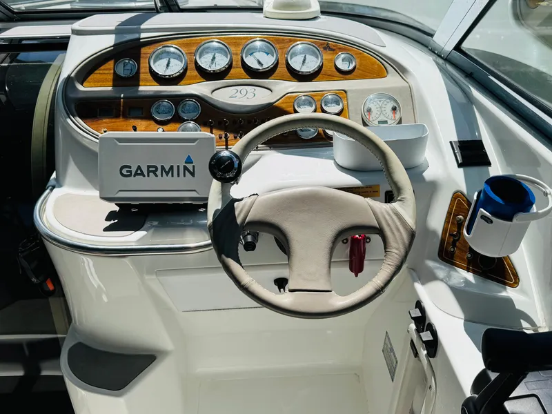Slide: The Image of Cockpit of 1998 Cobalt 293 boat with Garmin navigation system and wood-accented dashboard. - 22
