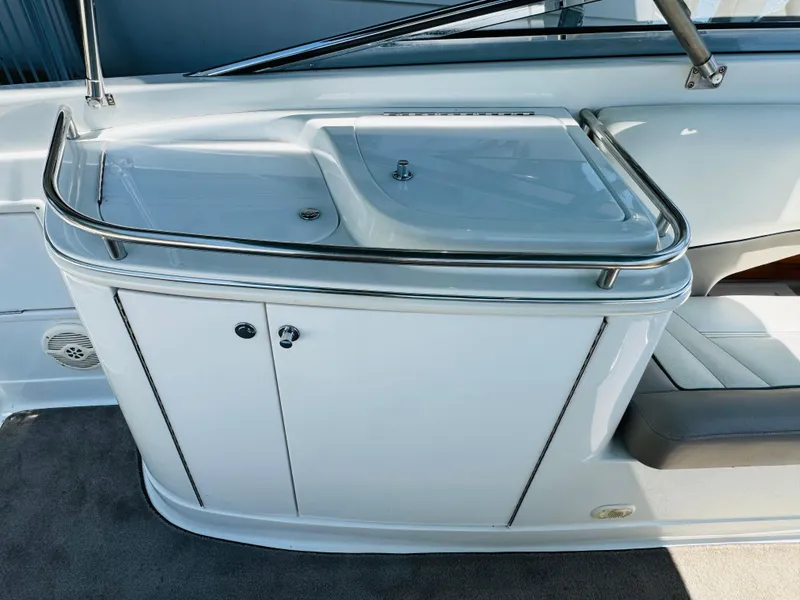 Slide: The Image of 1998 Cobalt 293 boat interior with sleek white cabinetry and seating. - 23