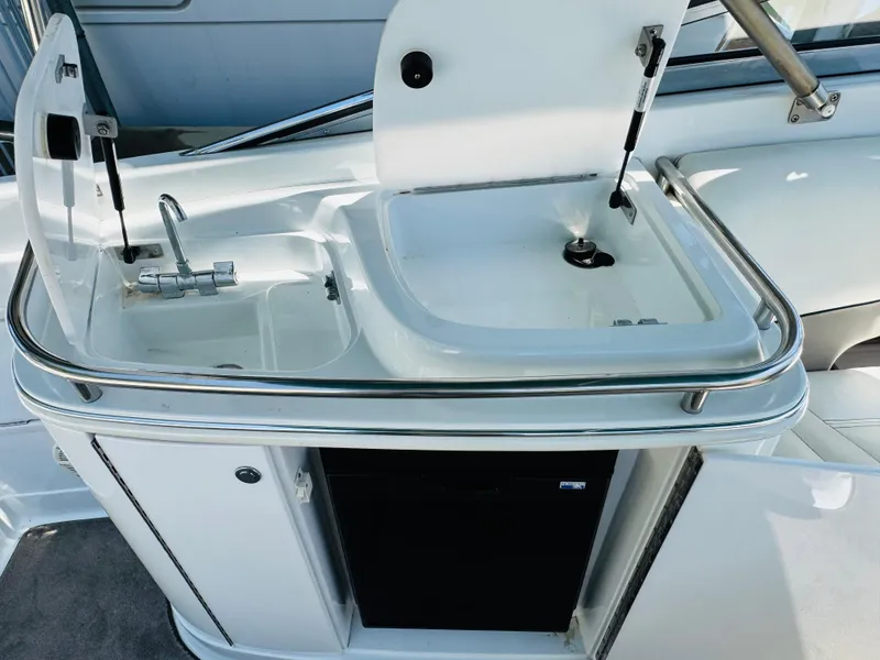Slide: The Image of 1998 Cobalt 293 boat kitchenette with sink and storage. - 24