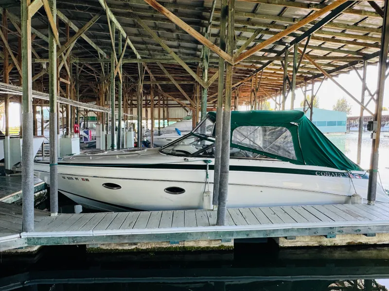Slide: The Image of 1998 Cobalt 293 boat docked under covered marina. - 3