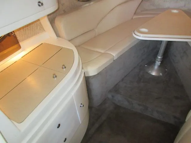 Slide: The Image of 1998 Cobalt 293 interior with beige seating and compact dining area. - 35