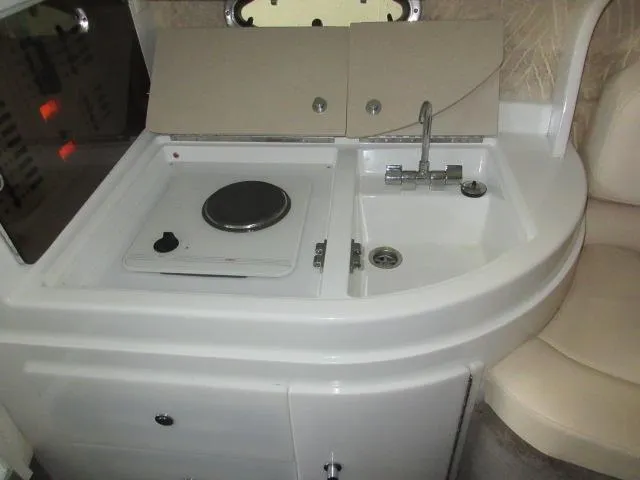 Slide: The Image of Compact kitchen area in a 1998 Cobalt 293 boat with stove and sink. - 39