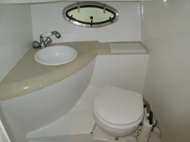 Slide: The Image of Compact bathroom in a 1998 Cobalt 293 boat with sink and toilet. - 41