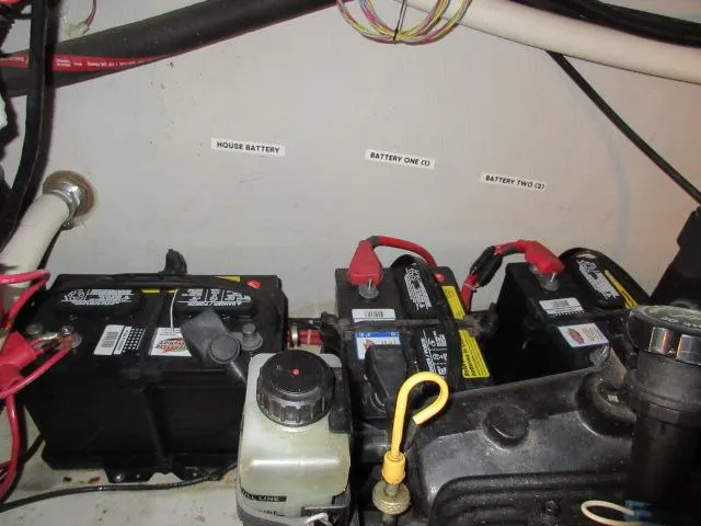 Slide: The Image of Battery compartment of a 1998 Cobalt 293 boat with labeled house and engine batteries. - 49