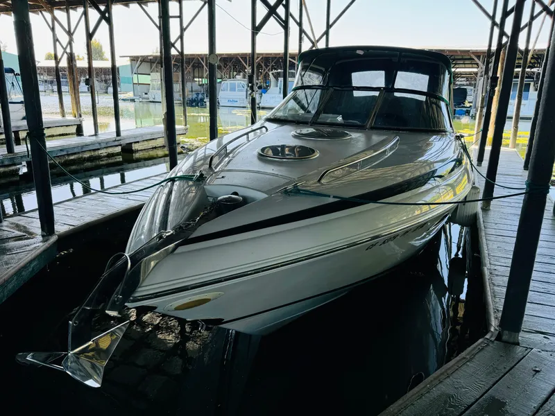 Slide: The Image of 1998 Cobalt 293 boat docked in a marina, featuring sleek design and covered cabin. - 5