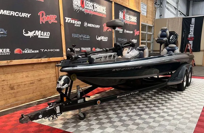 Slide: The Image of 2010 Ranger Z520 bass boat on trailer in showroom with branded backdrop. - 3