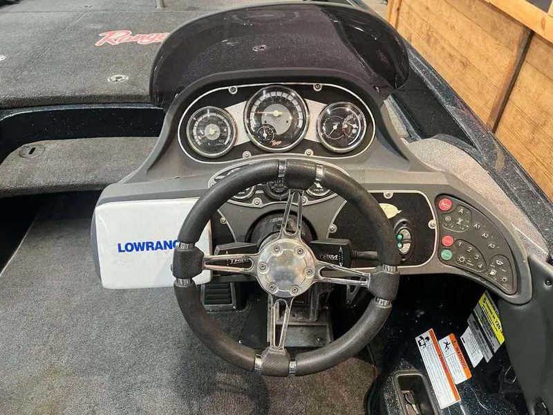 Slide: The Image of 2010 Ranger Z520 boat dashboard with steering wheel and Lowrance electronics. - 5
