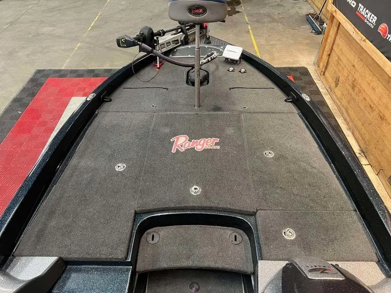 Slide: The Image of 2010 Ranger Z520 boat deck with logo, featuring fishing equipment and storage compartments. - 6