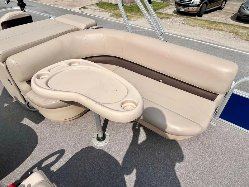 Slide: The Image of 2017 Sun Tracker Fishin' Barge 22 DLX with beige seating and a built-in table. - 13
