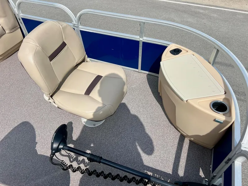 Slide: The Image of 2017 Sun Tracker Fishin' Barge 22 DLX interior with seating and storage console. - 15