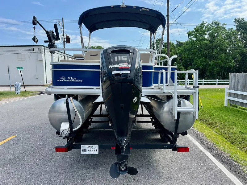 Slide: The Image of 2017 Sun Tracker Fishin' Barge 22 DLX pontoon boat with 115 Pro XS motor on a road. - 3