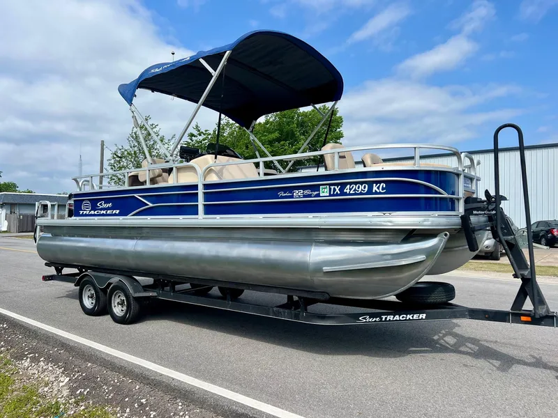Slide: The Image of 2017 Sun Tracker Fishin' Barge 22 DLX pontoon boat on trailer, parked roadside. - 5