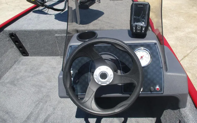 Slide: The Image of 2025 Tracker BASS TRACKER® Classic XL dashboard with steering wheel and navigation display. - 4