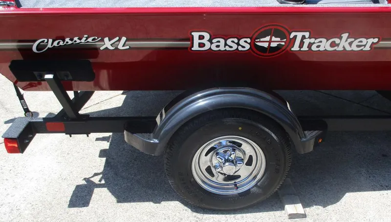 Slide: The Image of 2025 Tracker BASS TRACKER® Classic XL boat trailer with chrome wheel and logo. - 9