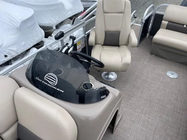 Slide: The Image of 2022 Sun Tracker Party Barge 20 DLX interior with helm and seating. - 11