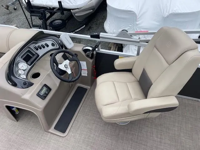 Slide: The Image of 2022 Sun Tracker Party Barge 20 DLX helm with beige captain's chair and control panel. - 13