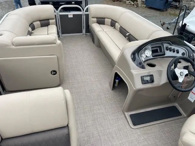 Slide: The Image of 2022 Sun Tracker Party Barge 20 DLX interior with beige seating and modern helm. - 14