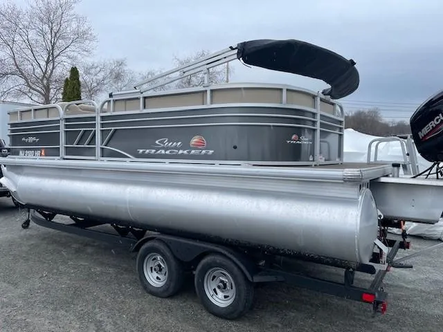 Slide: The Image of 2022 Sun Tracker Party Barge 20 DLX pontoon boat on trailer, overcast day. - 3