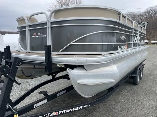 Slide: The Image of 2022 Sun Tracker Party Barge 20 DLX pontoon boat on trailer, parked outdoors. - 4