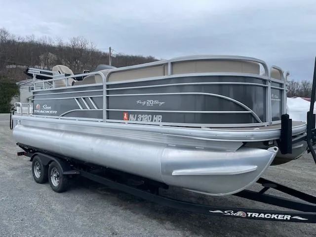 Slide: The Image of 2022 Sun Tracker Party Barge 20 DLX pontoon boat on trailer, parked outdoors. - 5