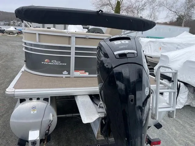 Slide: The Image of 2022 Sun Tracker Party Barge 20 DLX with Mercury 90 engine, parked outdoors. - 9