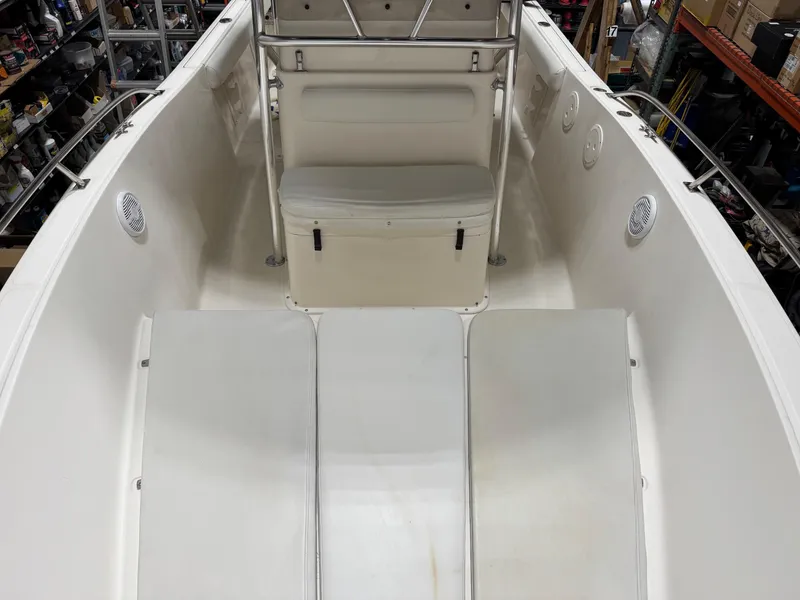 Slide: The Image of 2004 Pursuit 2470 CC boat interior with seating and storage compartments. - 12
