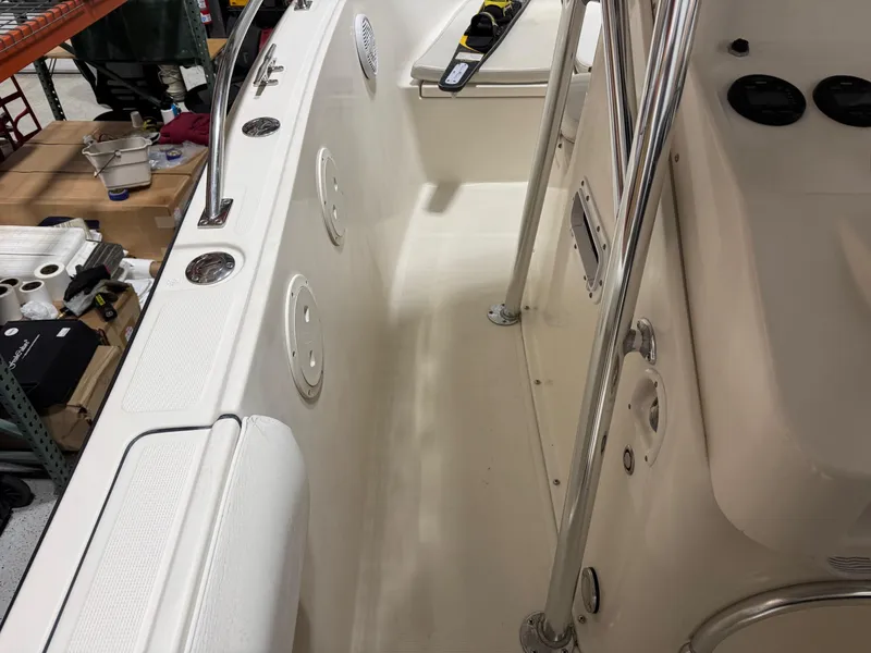 Slide: The Image of 2004 Pursuit 2470 CC boat interior with clean deck and stainless steel fittings. - 14