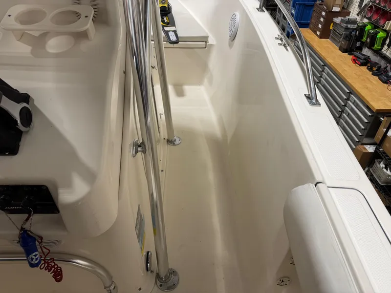 Slide: The Image of 2004 Pursuit 2470 CC boat interior with railings and storage compartments. - 15