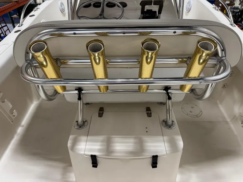 Slide: The Image of 2004 Pursuit 2470 CC boat with gold rod holders and steering console. - 18