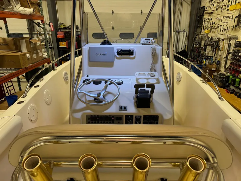 Slide: The Image of 2004 Pursuit 2470 CC boat cockpit with steering wheel and navigation equipment. - 26