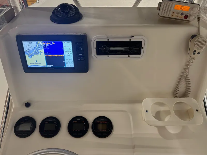 Slide: The Image of Control panel of a 2004 Pursuit 2470 CC boat with navigation and communication equipment. - 28