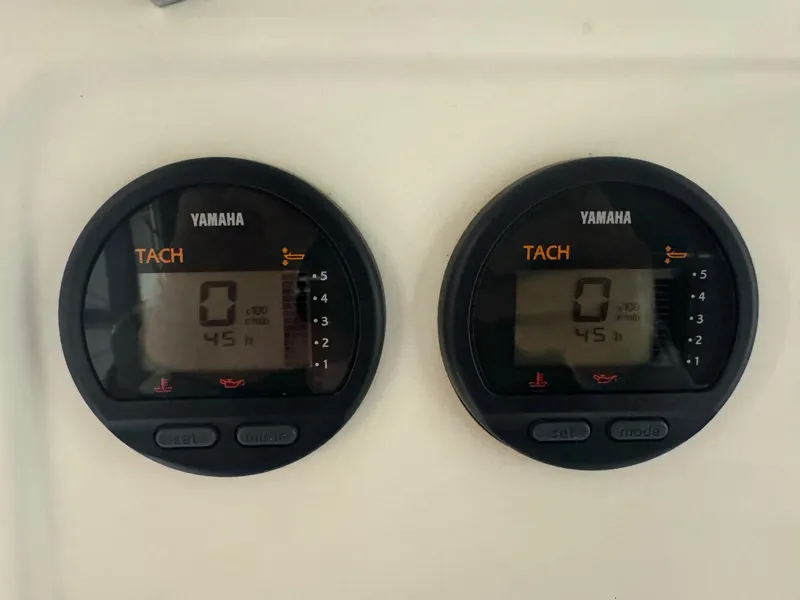 Slide: The Image of Yamaha tachometers on a 2004 Pursuit 2470 CC boat dashboard, displaying zero RPM. - 30