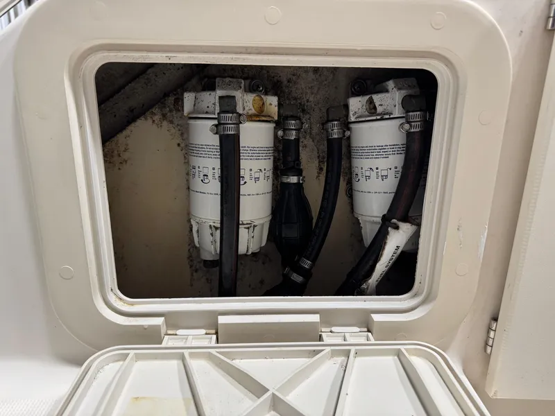Slide: The Image of Fuel filters inside a 2004 Pursuit 2470 CC boat compartment. - 32