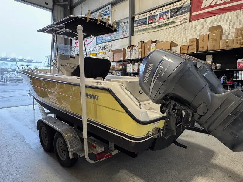 Slide: The Image of 2004 Pursuit 2470 CC boat with Yamaha engine on trailer in a garage. - 6