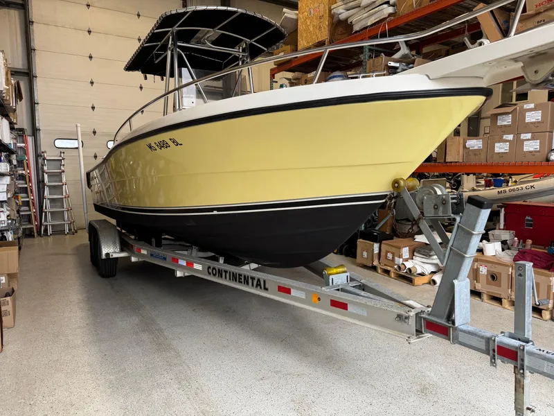 Slide: The Image of 2004 Pursuit 2470 CC boat on trailer in storage facility. - 7