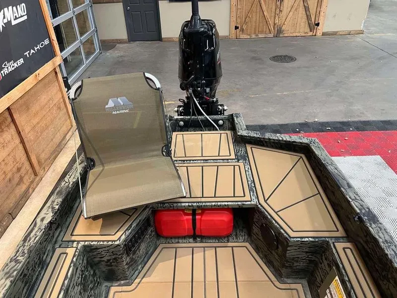 Slide: The Image of 2025 Tracker Grizzly® 1650 T Prairie Wings Edition boat interior with seating and motor. - 7