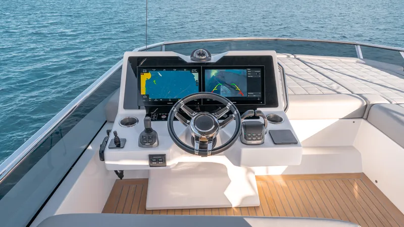 Slide: The Image of Helm of 2024 Pardo Yachts E60 with dual navigation screens and modern controls. - 18