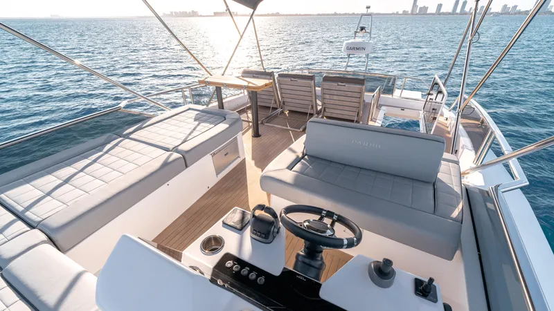 Slide: The Image of Luxurious 2024 Pardo Yachts E60 deck with seating, steering, and ocean view. - 25